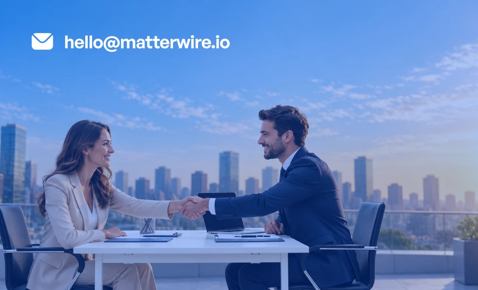 Two colleagues shaking hands over a desk, with the Matterwire contact email displayed.